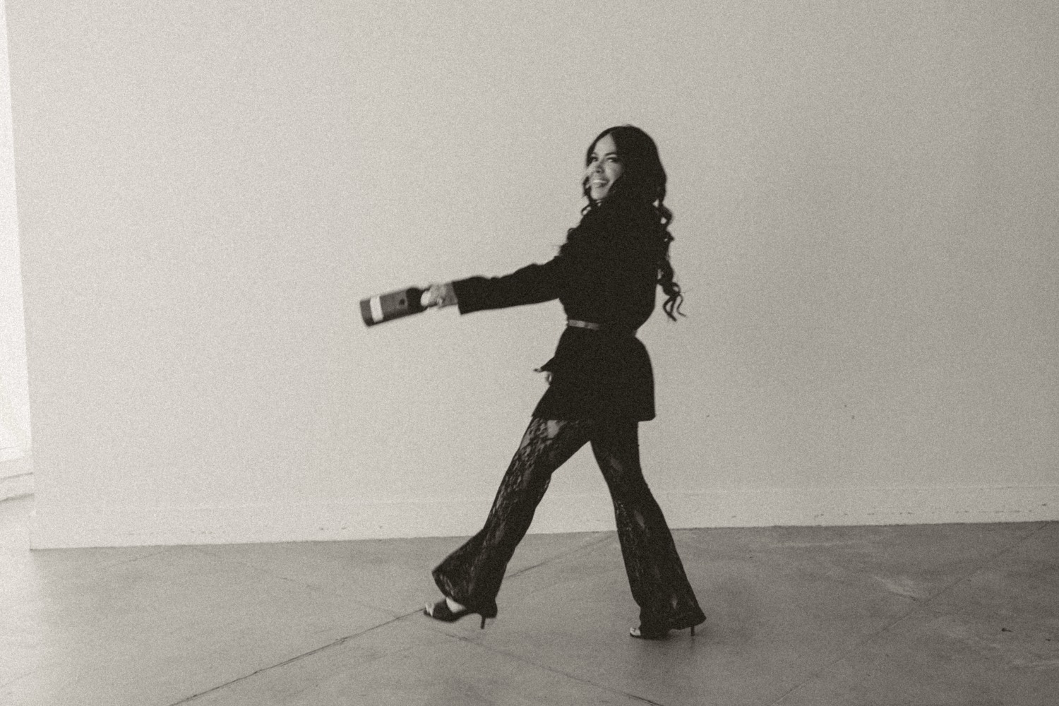 Britllin Noe, founder and broker of The Brokerage Collective, walking and laughing with a lockbox in her hand